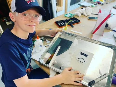 a boy holding a drawing