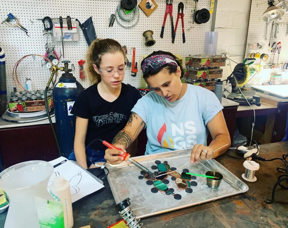 a couple of women working on a project