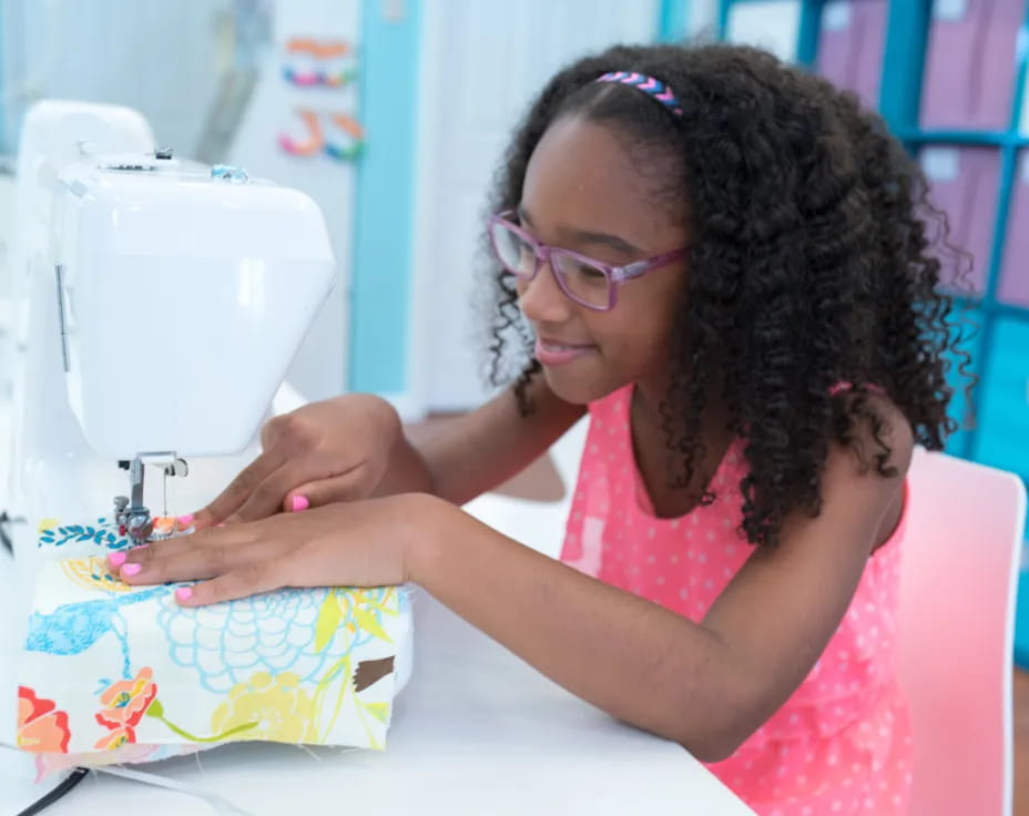 a person using a sewing machine