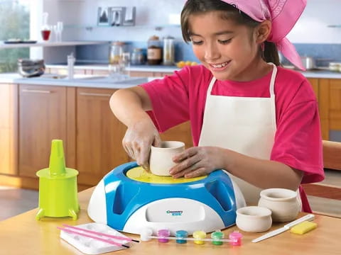 a girl making a tea cup