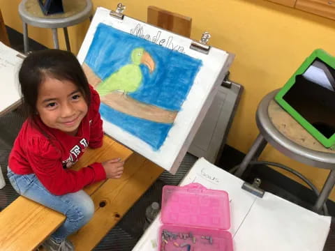 a girl painting on a canvas