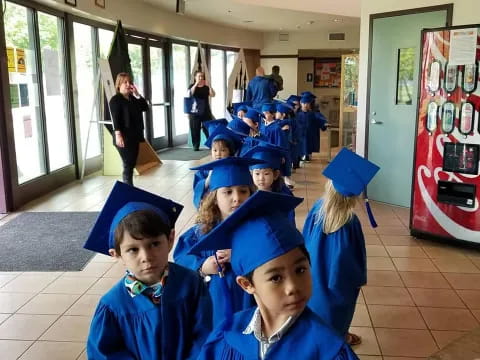 a group of children in graduation gowns