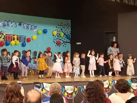 a group of children performing on a stage