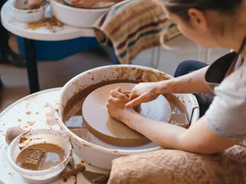 a person washing a bowl of water