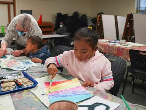 a person and a boy painting