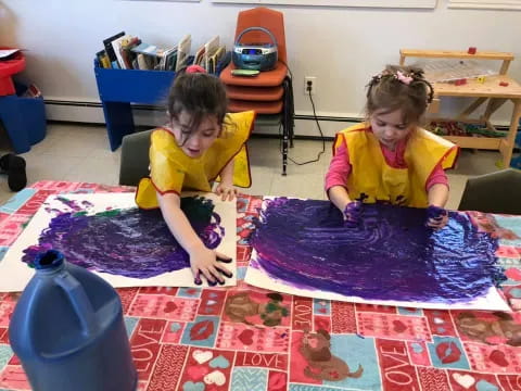 a couple of children playing on a rug