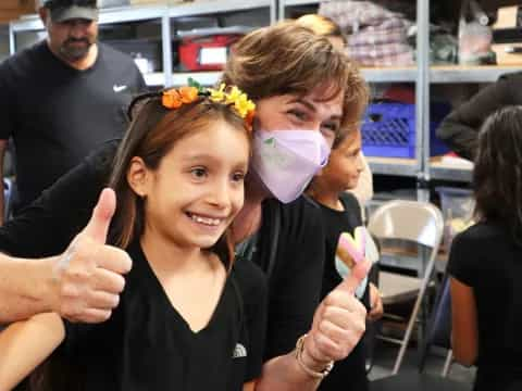 a couple girls with flowers on their faces