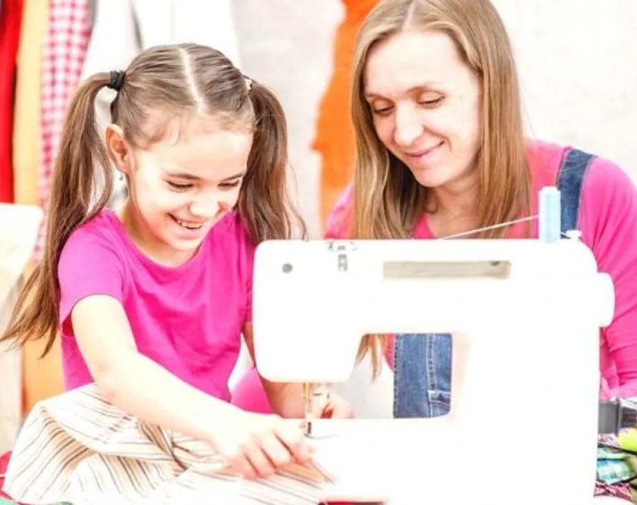 a person and a girl looking at a tablet