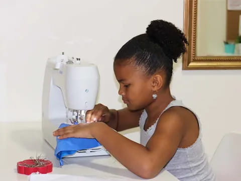 a person using a sewing machine