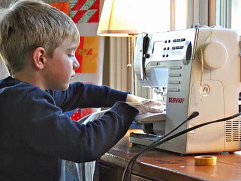 a young boy looking at a microscope