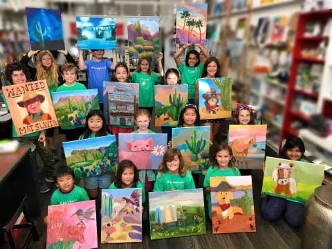 a group of children holding up books