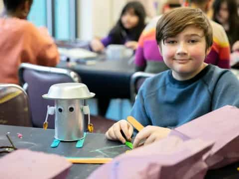 a boy sitting at a table