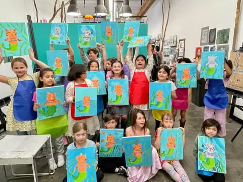 a group of children holding up posters