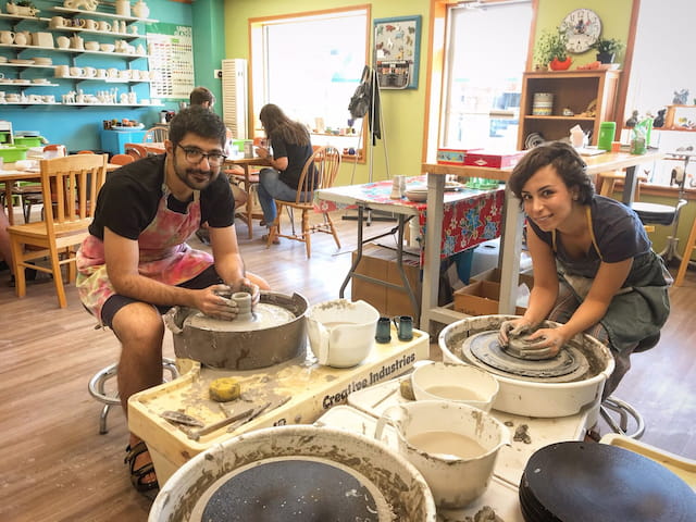 a man and woman working in a workshop