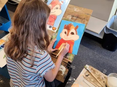 a girl painting on a table