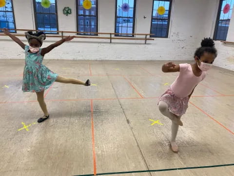 two girls dancing on a court