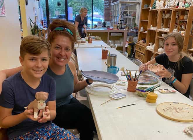 a group of people sitting at a table with a stuffed animal