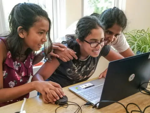 a group of kids using laptops