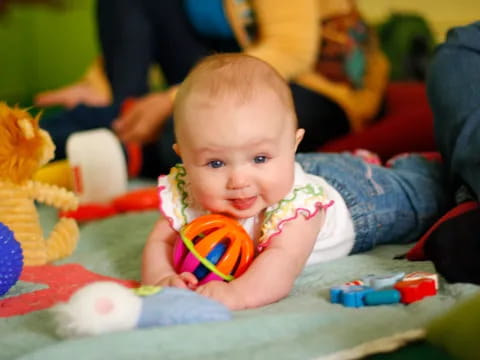 a baby lying on the floor