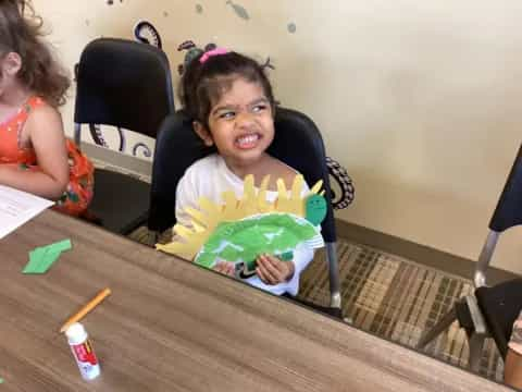 a girl sitting at a table