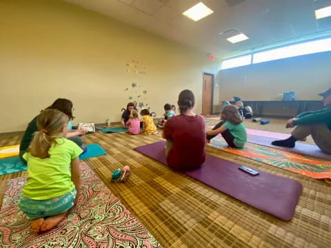 a group of children sitting on mats