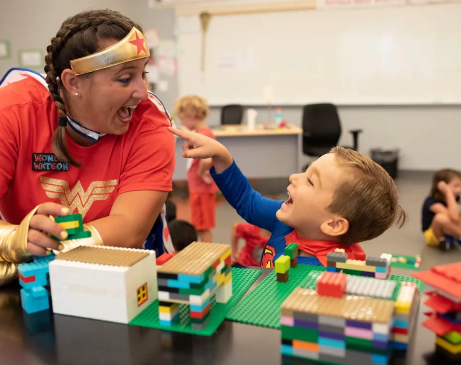 a person and a child playing with building blocks