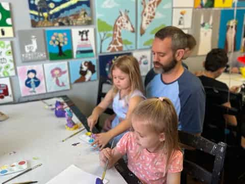 a group of people painting