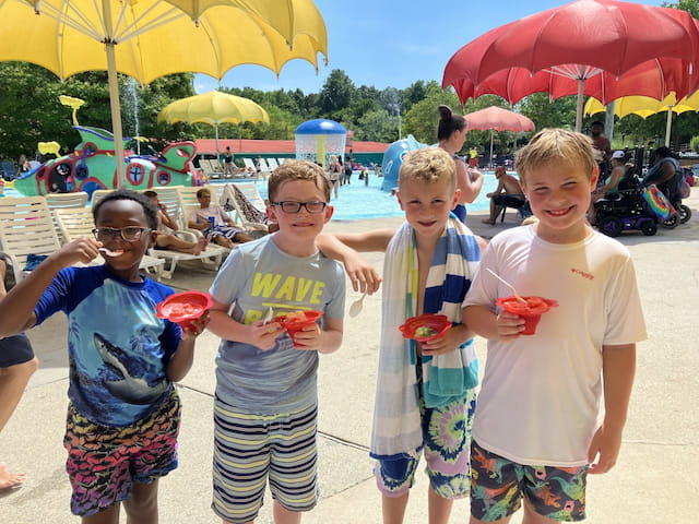 a group of kids holding watermelons