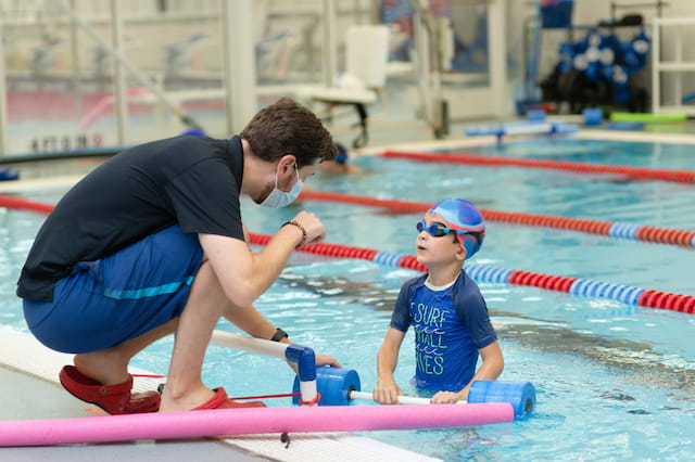 a man and a child in a pool