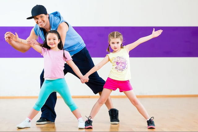 a person and two girls dancing