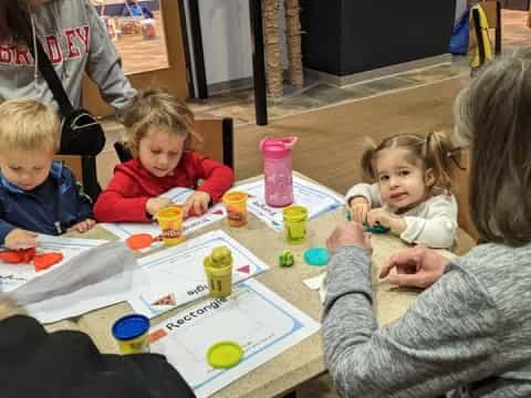 a group of children sitting at a table