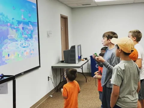 a group of kids looking at a screen