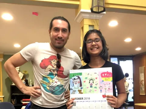 a man and a woman holding a framed picture