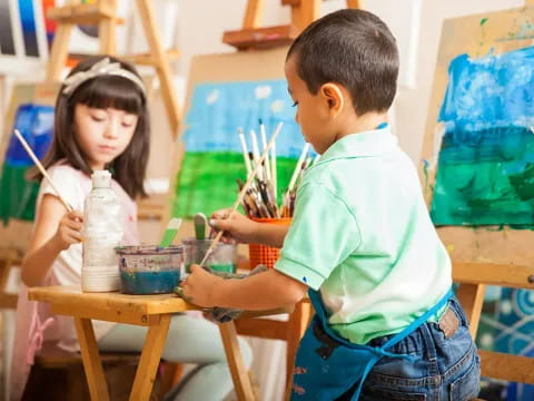 a young boy and girl painting