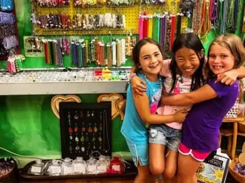 a group of girls posing for a picture in front of a store