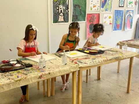 a group of young girls painting
