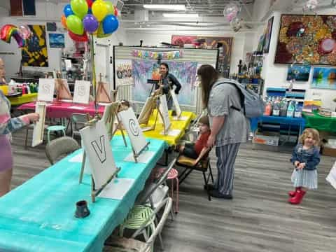 a person and a child at a table with balloons