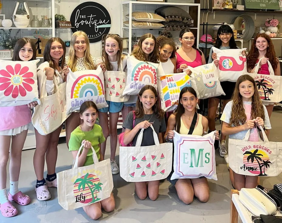 a group of girls holding bags