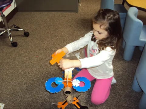 a girl playing with a toy