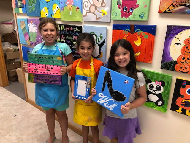 a group of children holding up posters