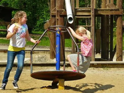 a couple of girls playing on a playground
