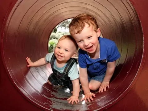 a couple of kids in a slide