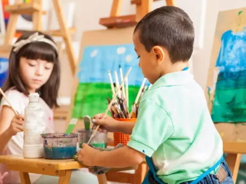 a boy and girl painting