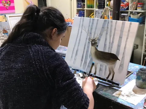 a person painting a bird