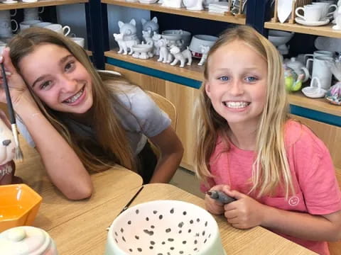 two girls sitting at a table