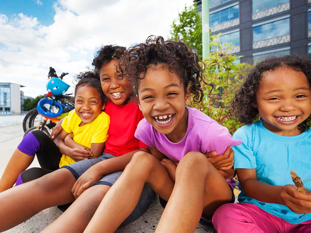 a group of children sitting on a bench