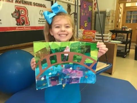 a girl holding a toy