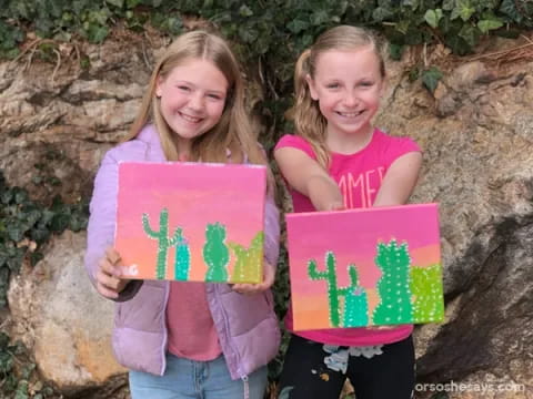 two girls holding signs