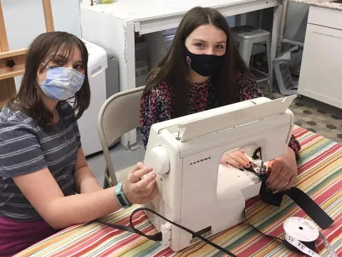 a person holding a sewing machine