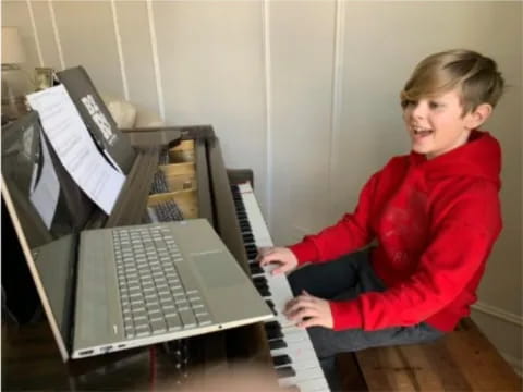 a boy playing a piano